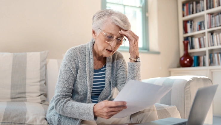 Woman reading a letter at home