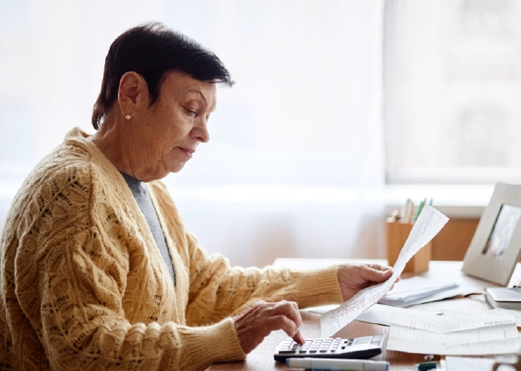 Person reviewing paperwork at home